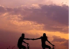 Two people on bicycles hold hands against a sunset sky. Our life