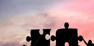 Silhouettes of people working together to fit giant puzzle pieces against a sunset background, embodying the spirit of challenges and personality development.