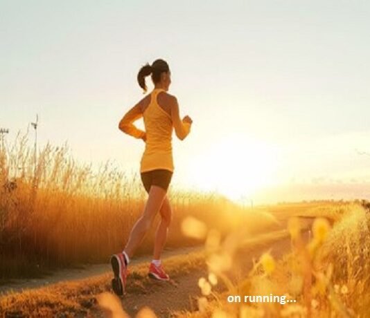 A person on running on a path through a field at sunset, embracing well-being in an orange top and shorts.