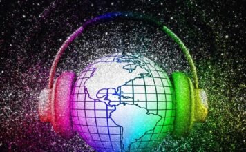 A globe with grid lines is encircled by headphones. The image is surrounded by a colorful, glittery background. The world is listening.