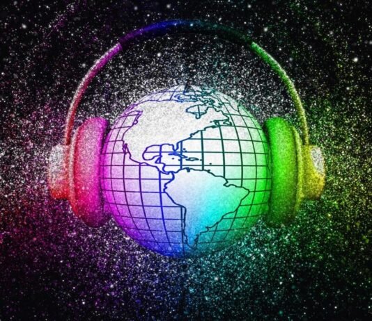 A globe with grid lines is encircled by headphones. The image is surrounded by a colorful, glittery background. The world is listening.