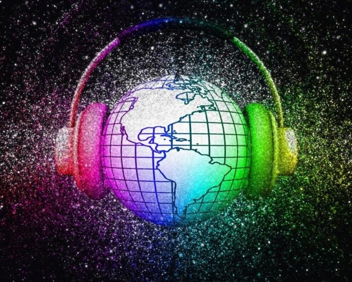 A globe with grid lines is encircled by headphones. The image is surrounded by a colorful, glittery background. The world is listening.