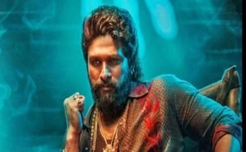 Allu Arjun with a beard and styled hair sits confidently in a colourful shirt and red pants, wearing multiple necklaces, resembling a icon star. The background features a blue-green glow.