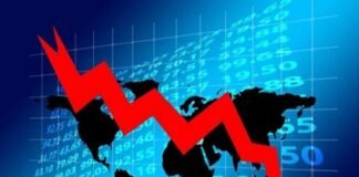 A red downward arrow in front of a world map and financial numbers highlights a global market decline, with particular implications for Indian economy slowing down