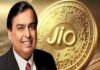 A smiling man in a suit stands proudly in front of a large Jio Coin, its embossed, circuit-like design gleaming with innovation.