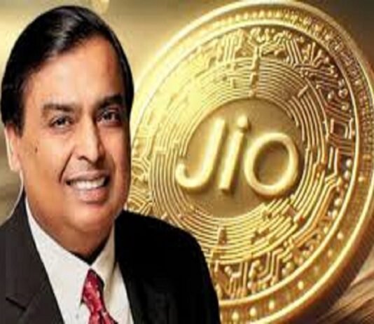 A smiling man in a suit stands proudly in front of a large Jio Coin, its embossed, circuit-like design gleaming with innovation.