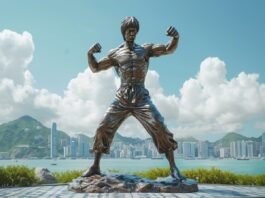 A bronze statue of a martial artist in a fighting stance graces the skyline, with urban towers and mountains looming behind—a testament to those who value art over spending money.